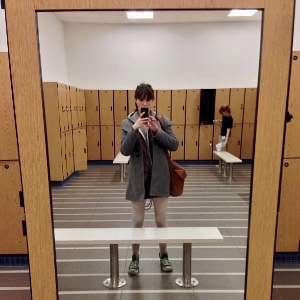 a man taking a picture of himself in a locker room