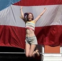 a woman jumping in the air with an american flag