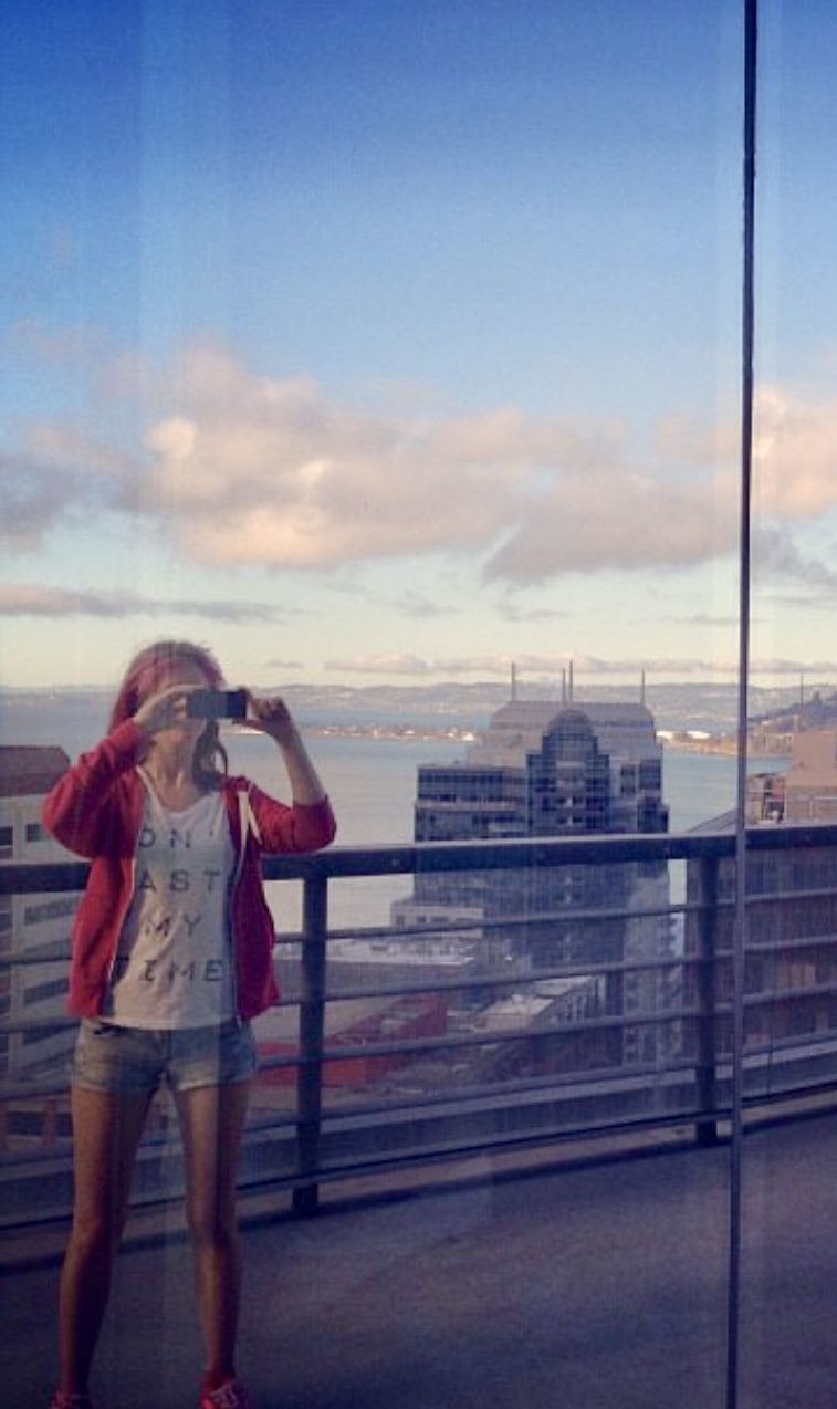 a woman taking a picture of a city