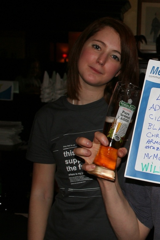 a woman holding a bottle of alcohol