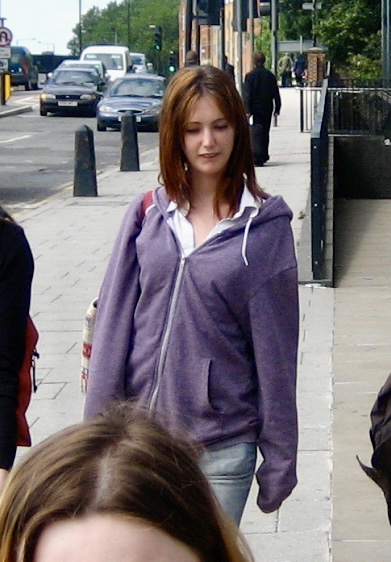 a woman walking down the sidewalk