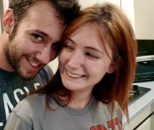 a man and woman are smiling in the kitchen