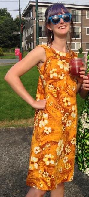 two girls in dresses and sunglasses stand next to each other women