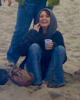 a woman sitting on the sand