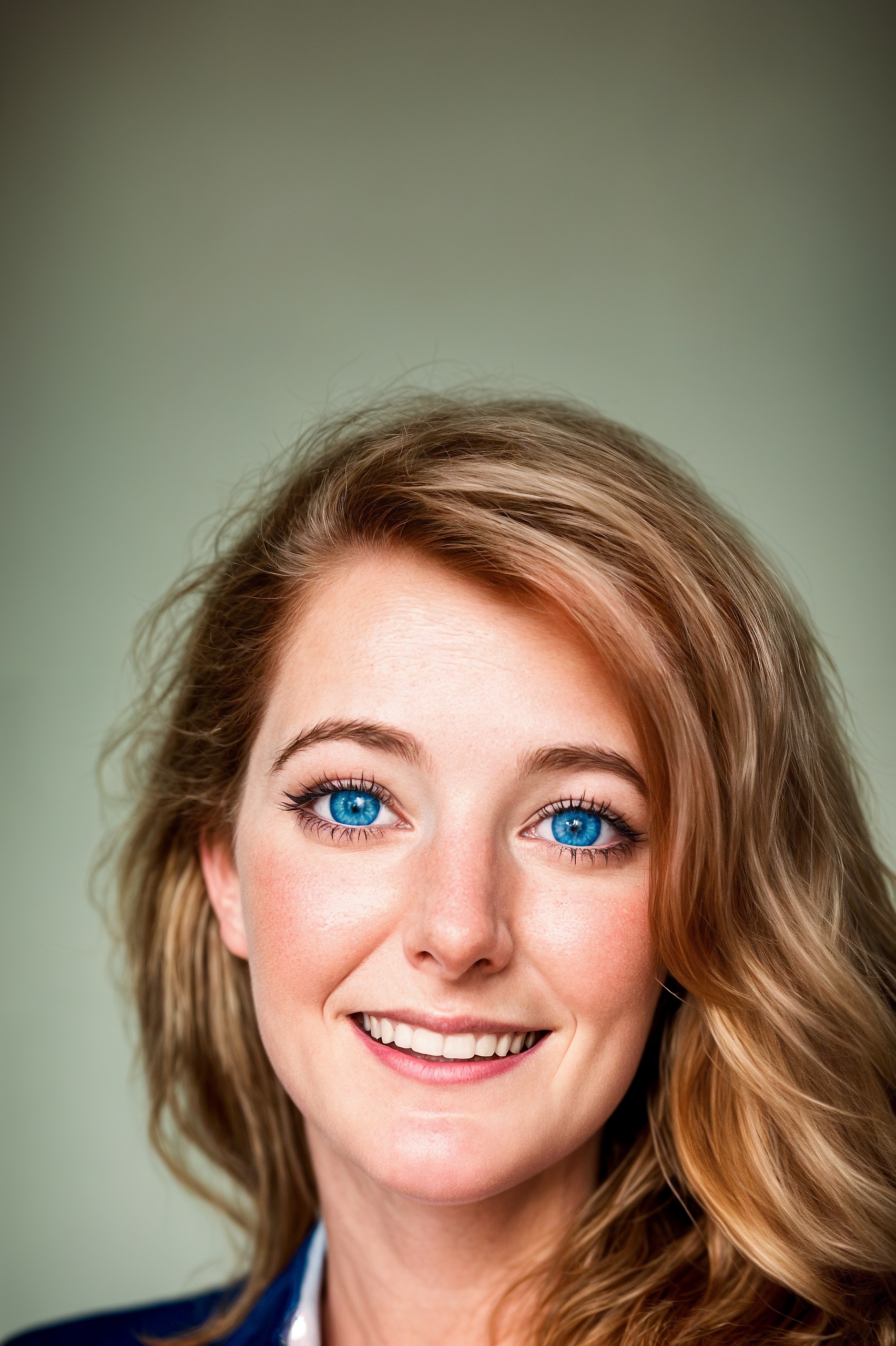 a woman with blue eyes and blonde hair