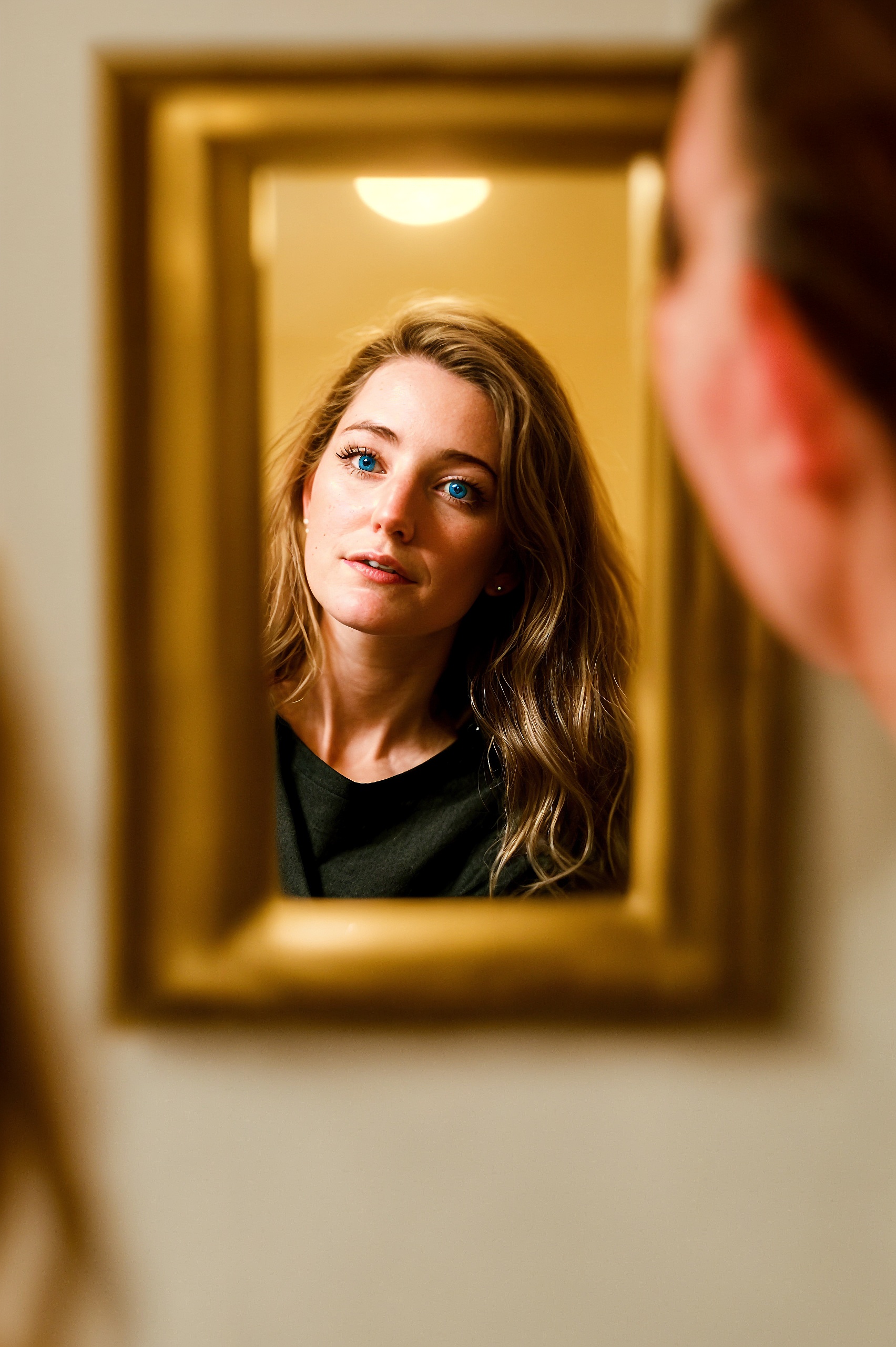 a woman looking at herself in a mirror