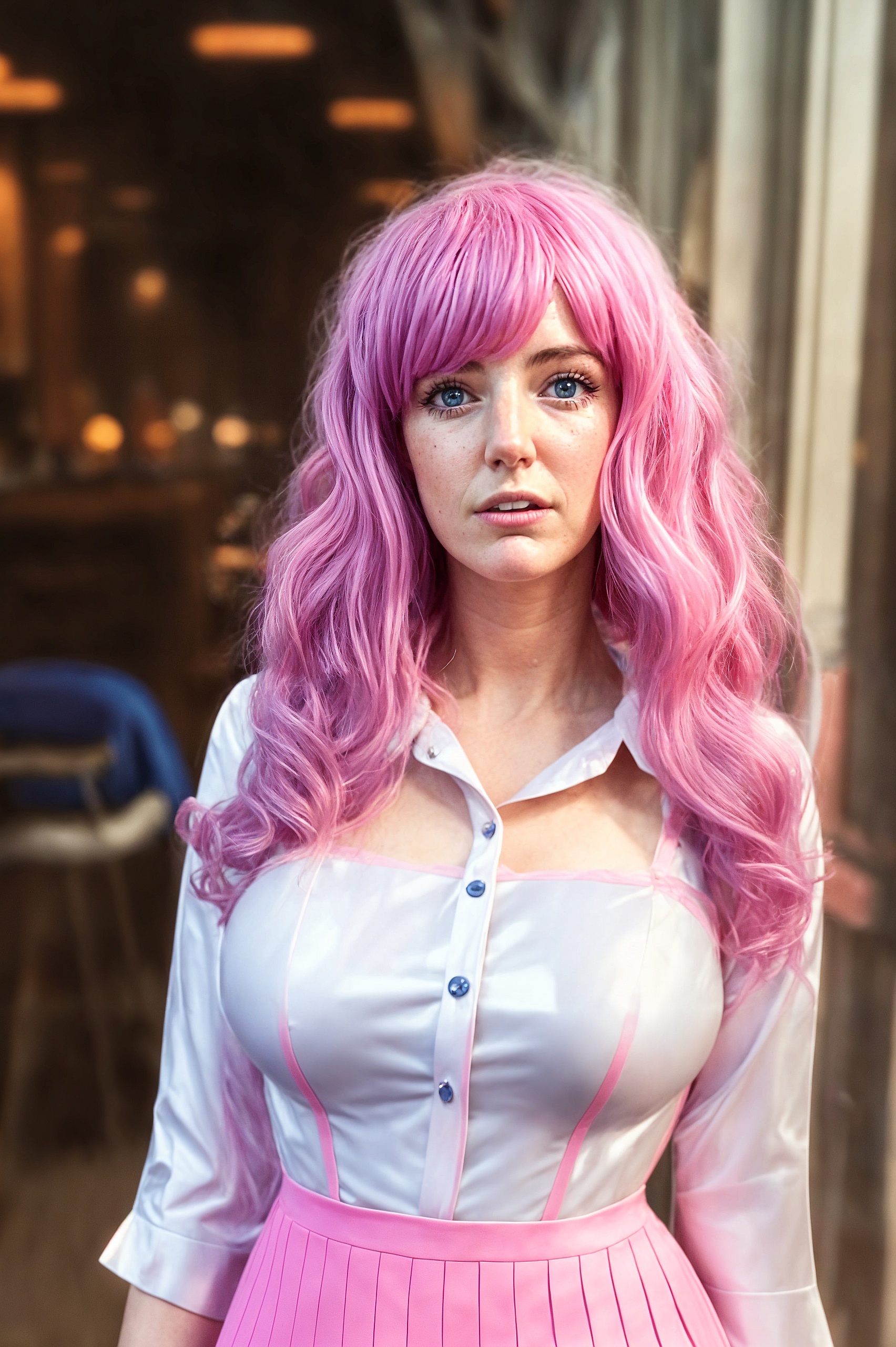 a woman with pink hair and a white shirt