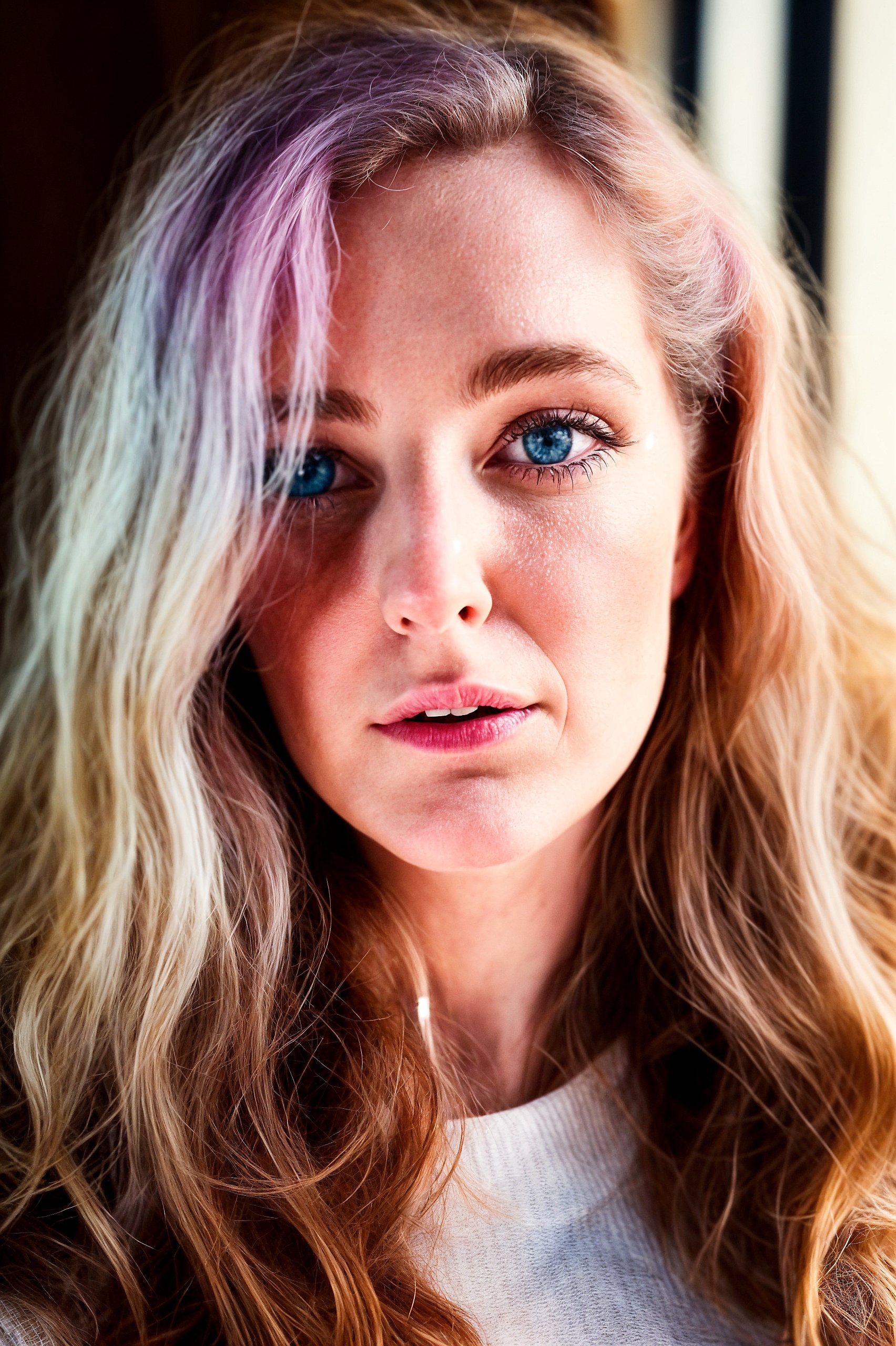 a woman with long blonde hair and blue eyes