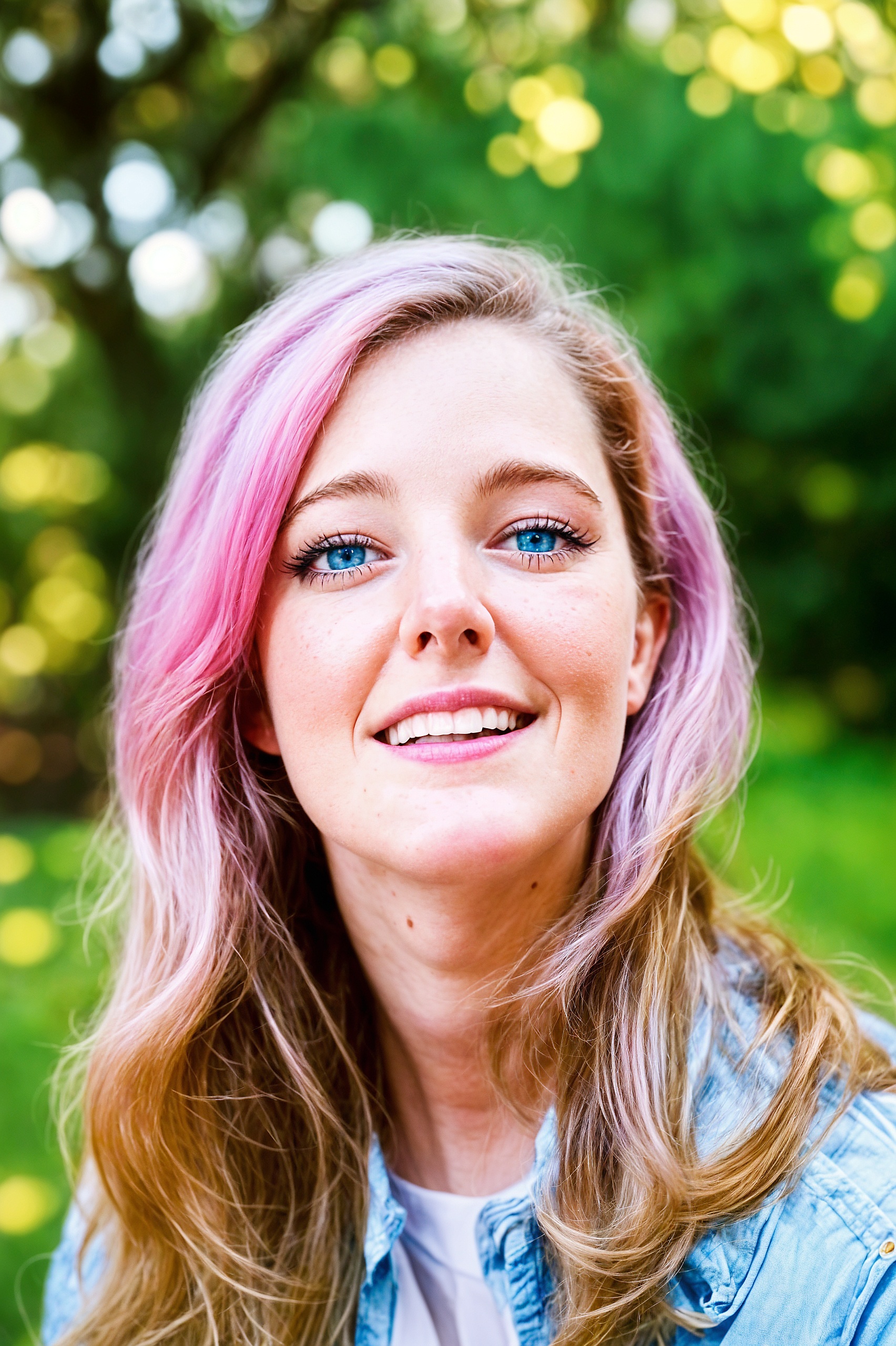 a woman with pink hair and blue eyes