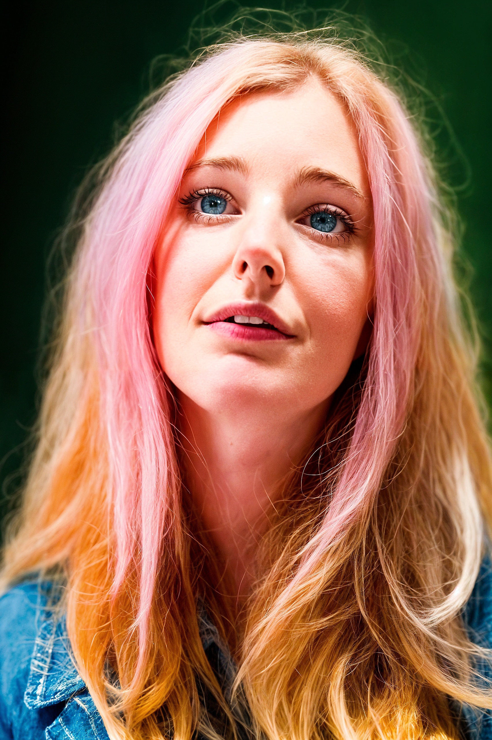 a woman with pink hair and blue eyes