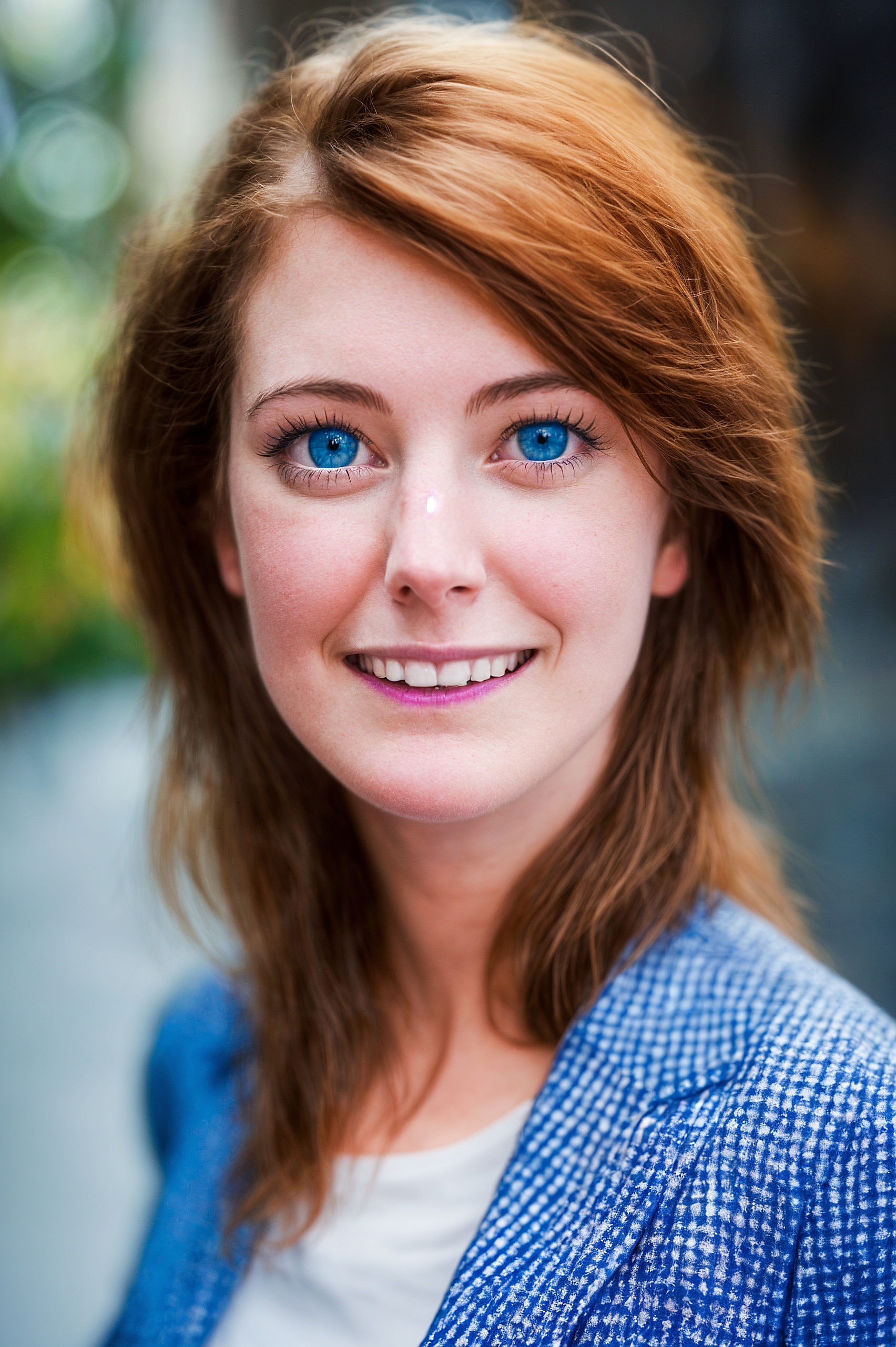 a woman with blue eyes and a white shirt