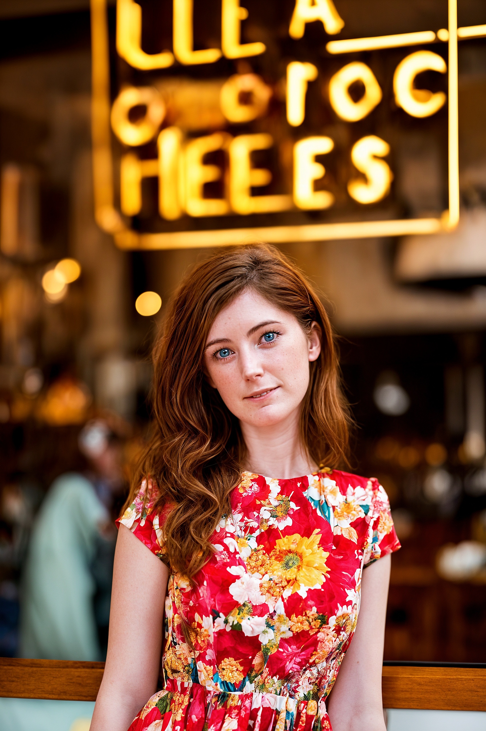 a woman sitting at a table in front of a restaurant