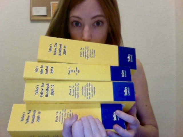 a woman holding a stack of yellow tickets