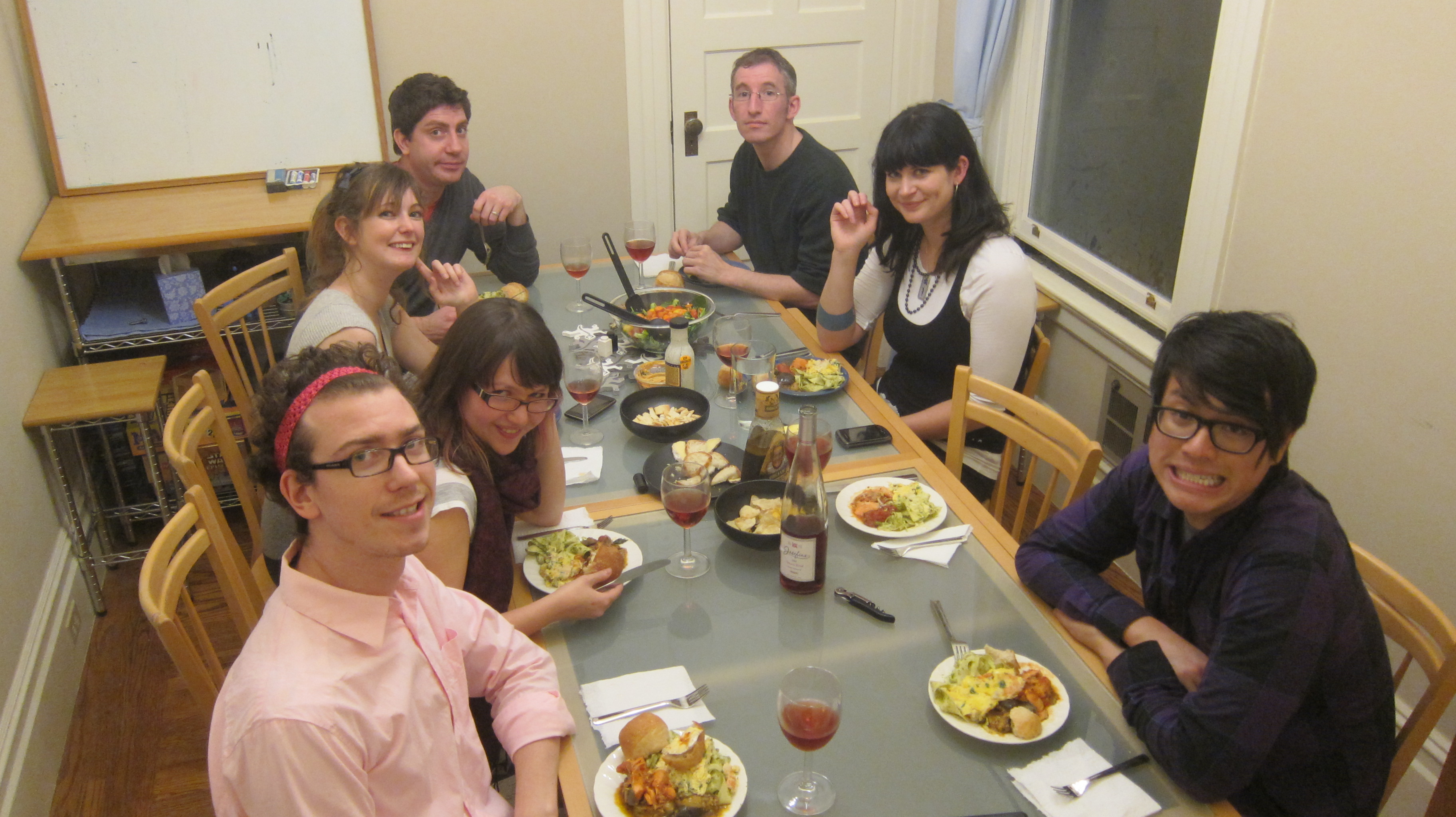 a group of people sitting around a table eating