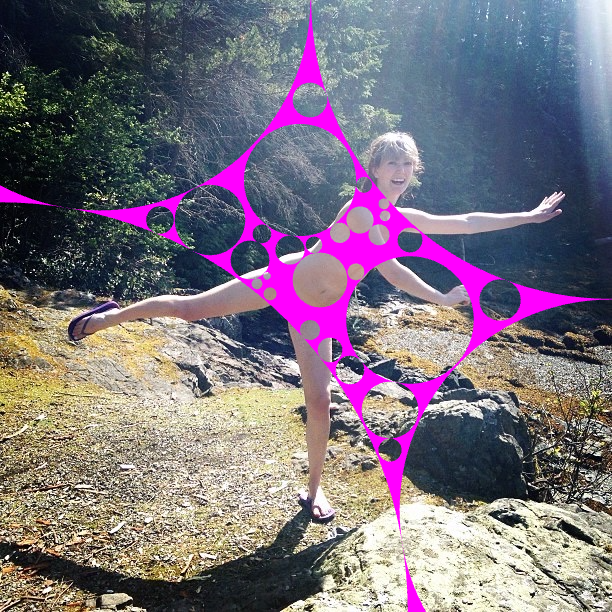 a woman in a pink bikini is standing on rocks