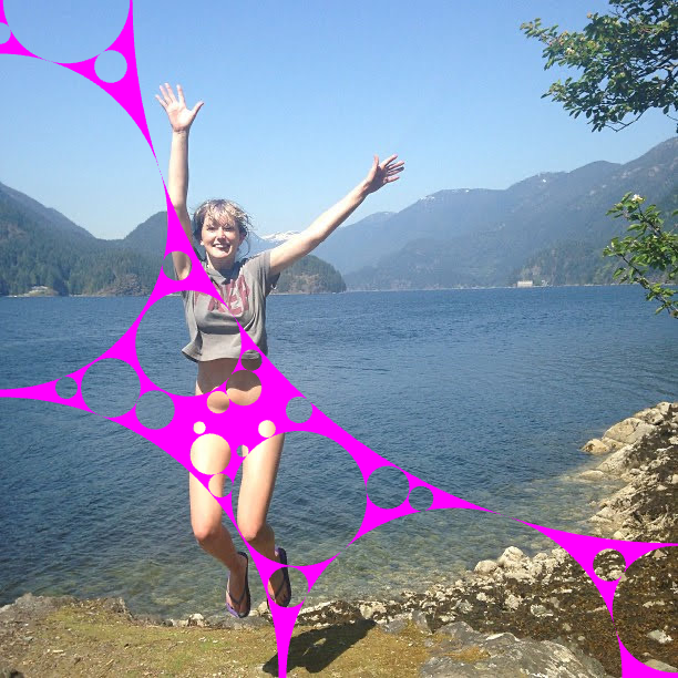 a woman jumping in the air near a lake