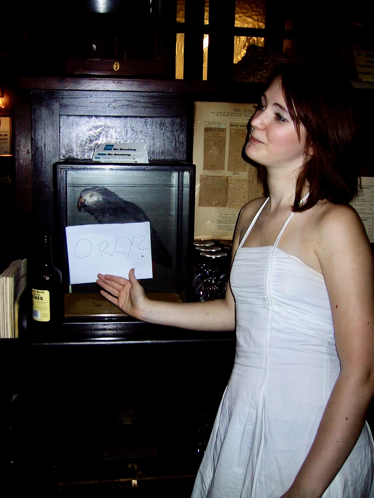 a woman in a white dress holding a piece of paper