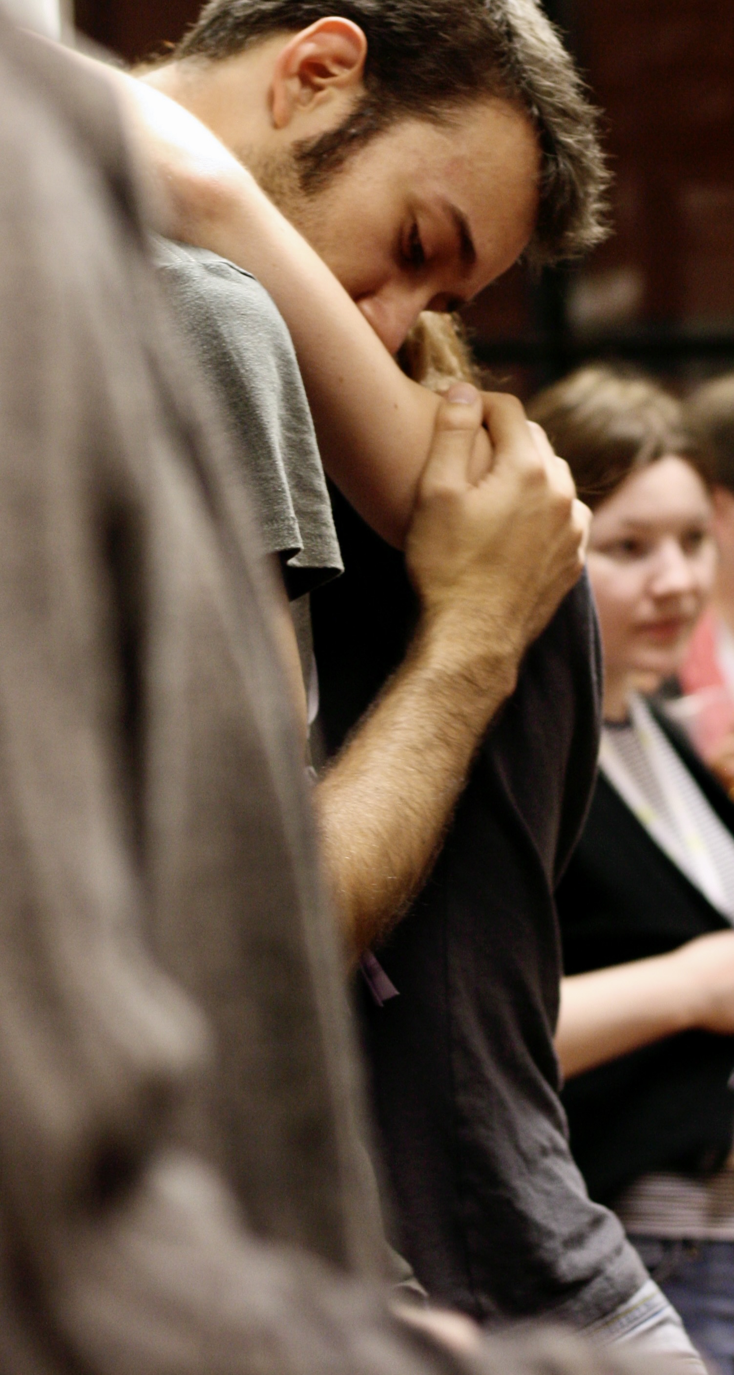 a man sitting down with his head in his hands