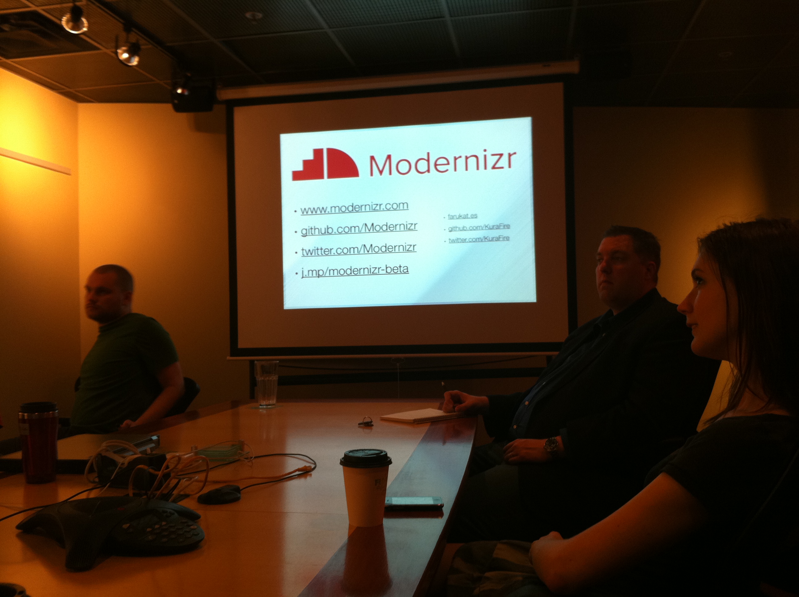 a group of people sitting around a conference table