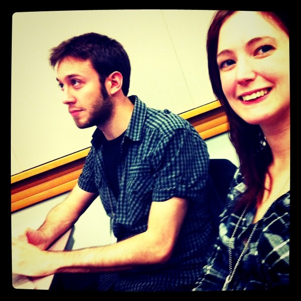 a man and woman sitting next to each other people