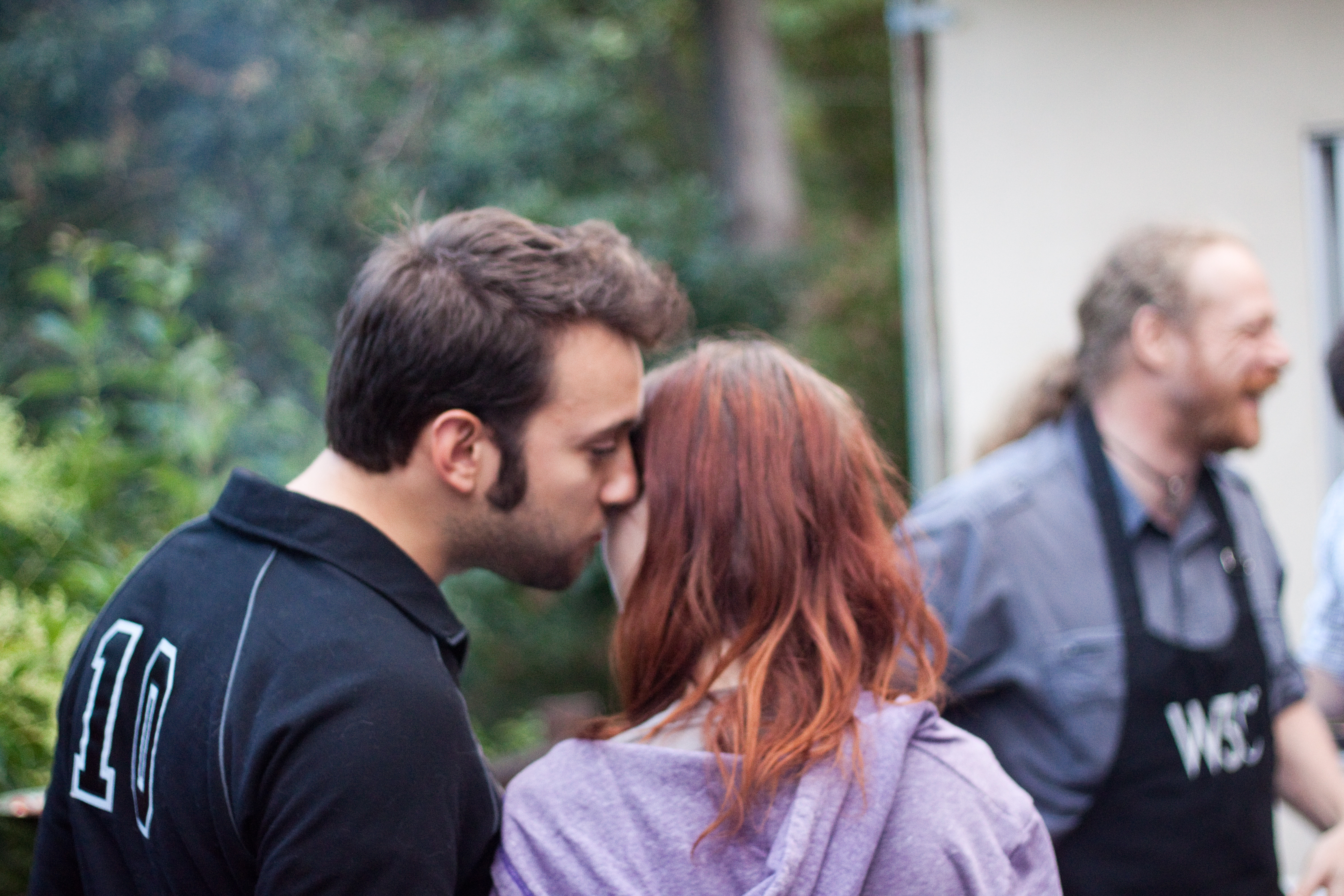 a man and woman standing next to each other people