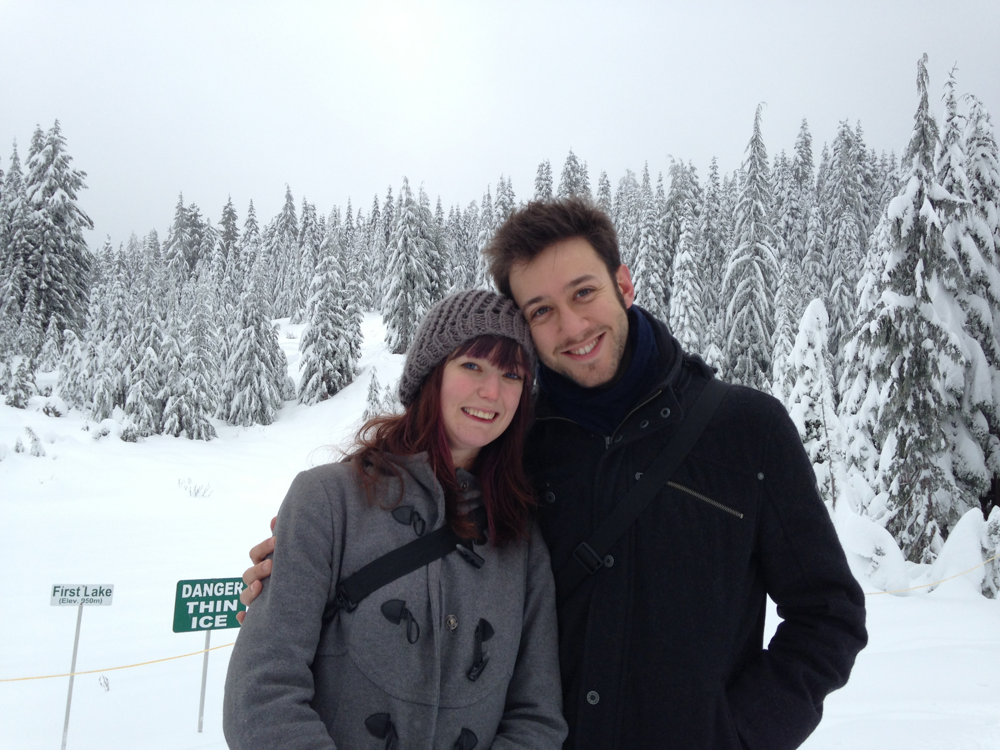 a man and woman standing in the snow ¢

DANGE
THIN
ICE
(Elev. 960m)
First Lake