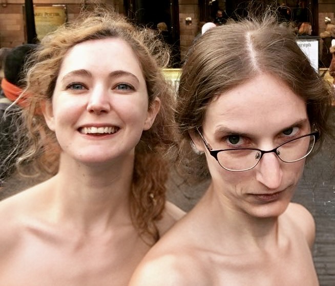 two women are posing for the camera