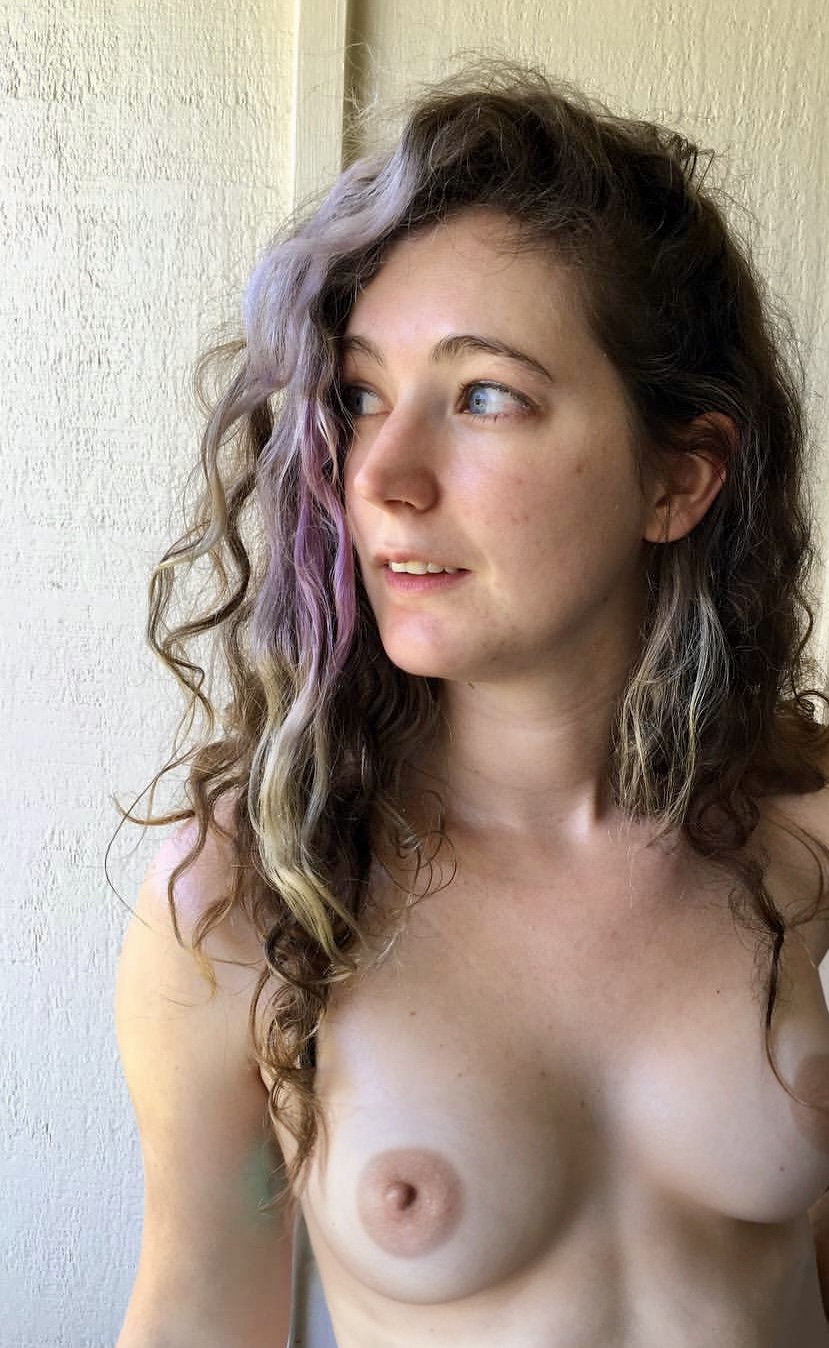 a naked woman with long hair and blue eyes