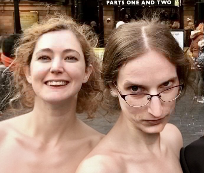 two women are posing for the camera