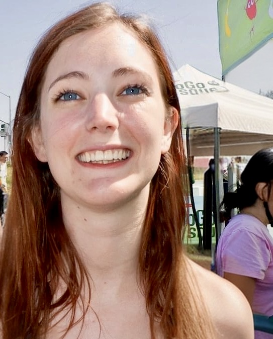 a woman with long red hair and blue eyes