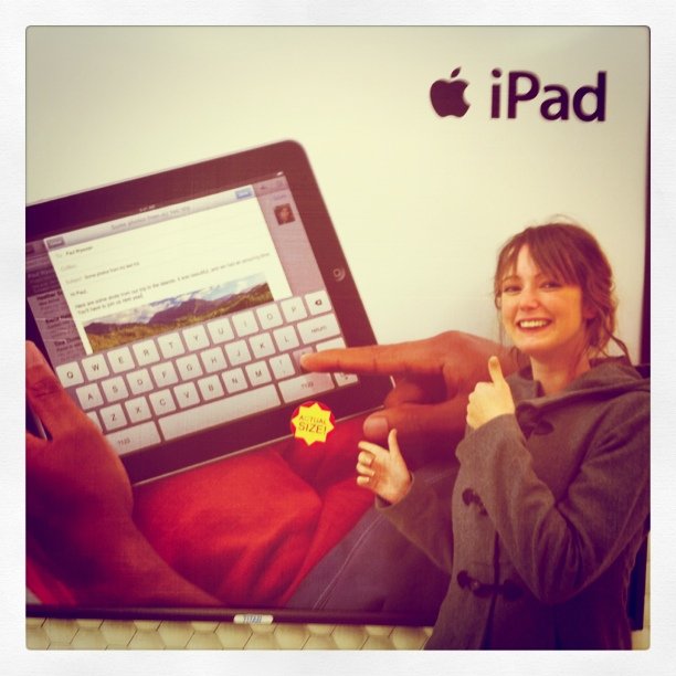 a woman is holding a star in front of a laptop