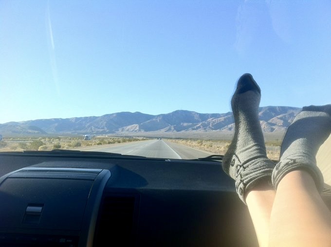 a person's feet are shown in the dashboard of a car