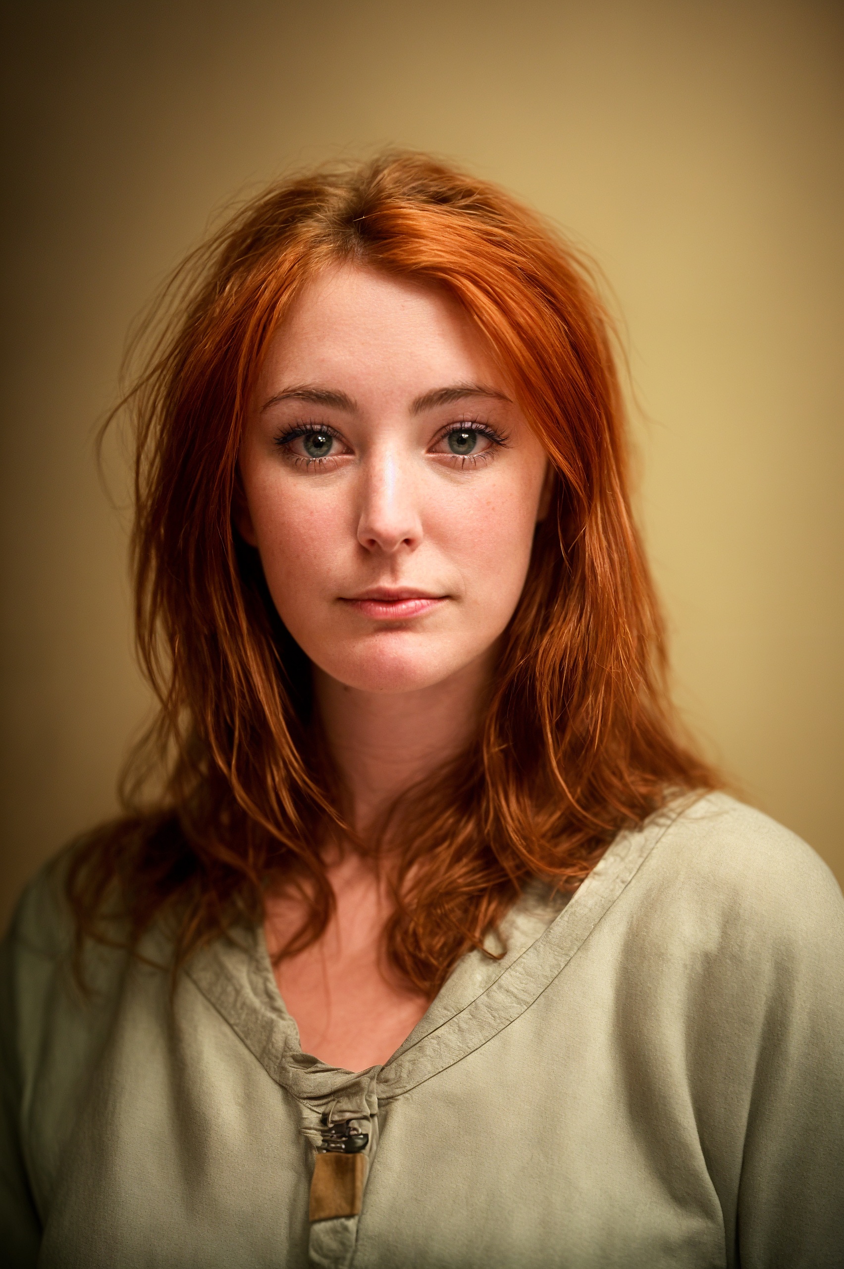 a woman with red hair and a green shirt