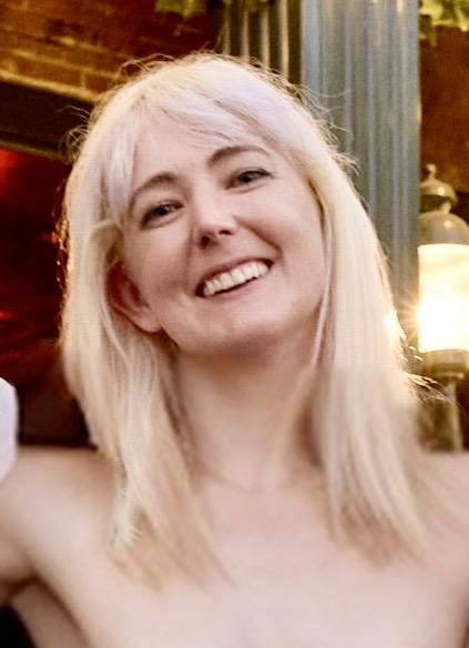 a woman with blonde hair and a white shirt