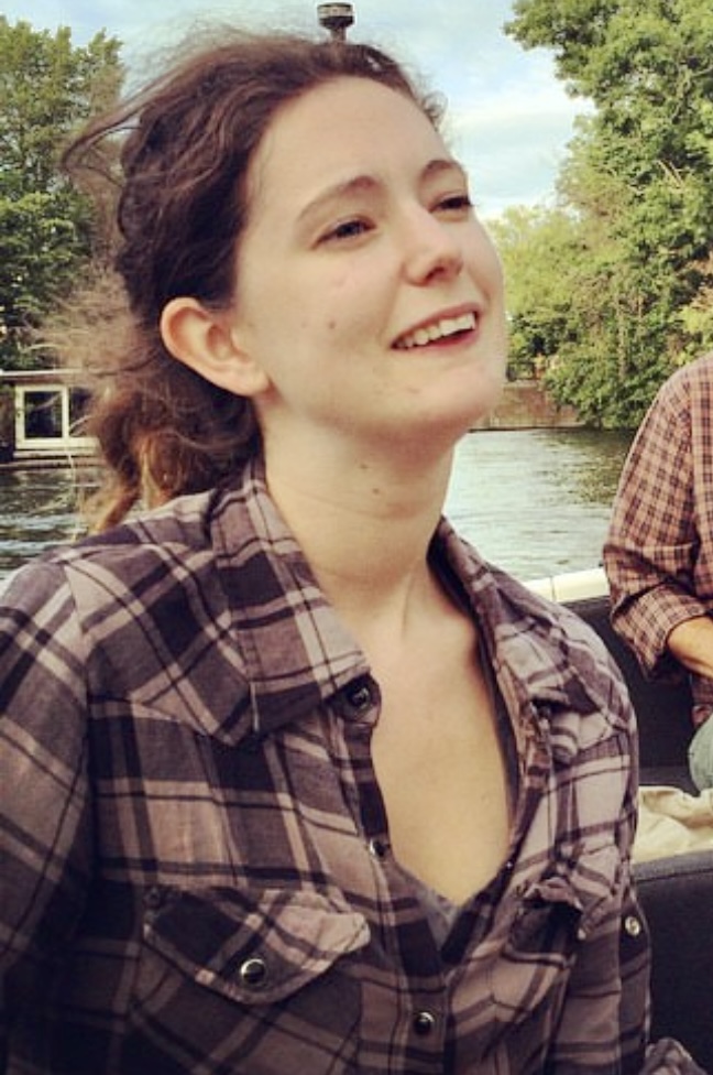 two people sitting on a boat in the water