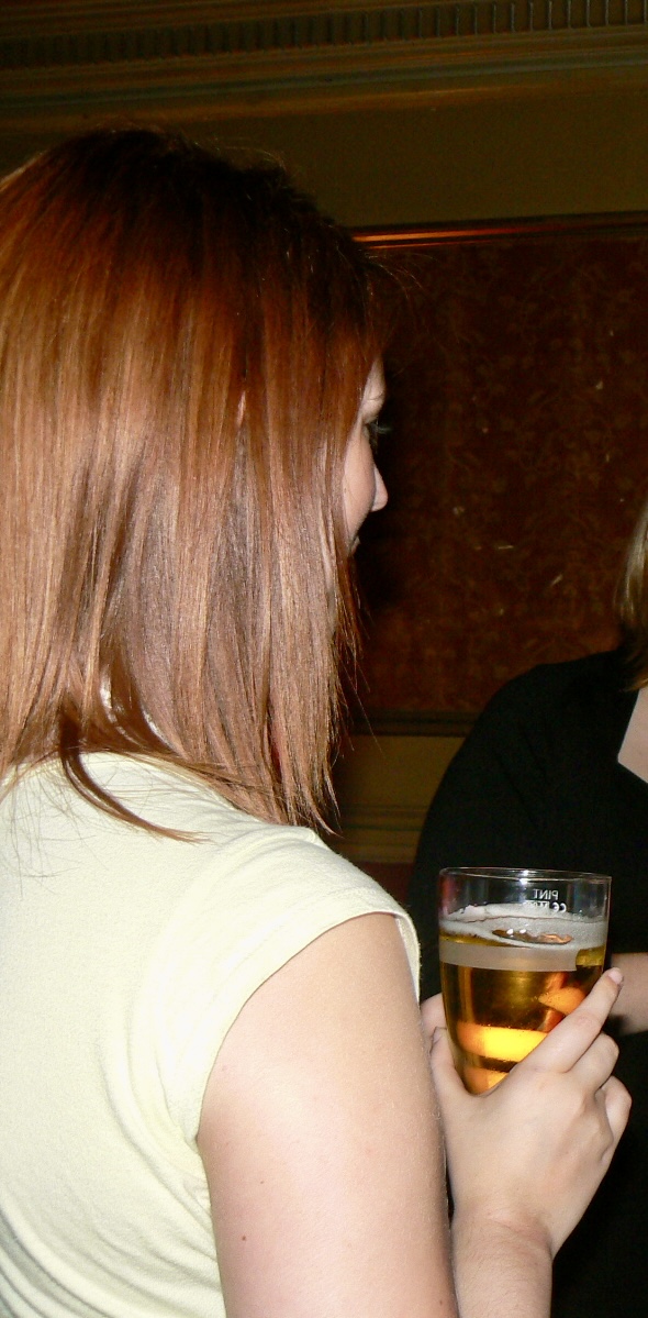 a woman holding a glass of beer