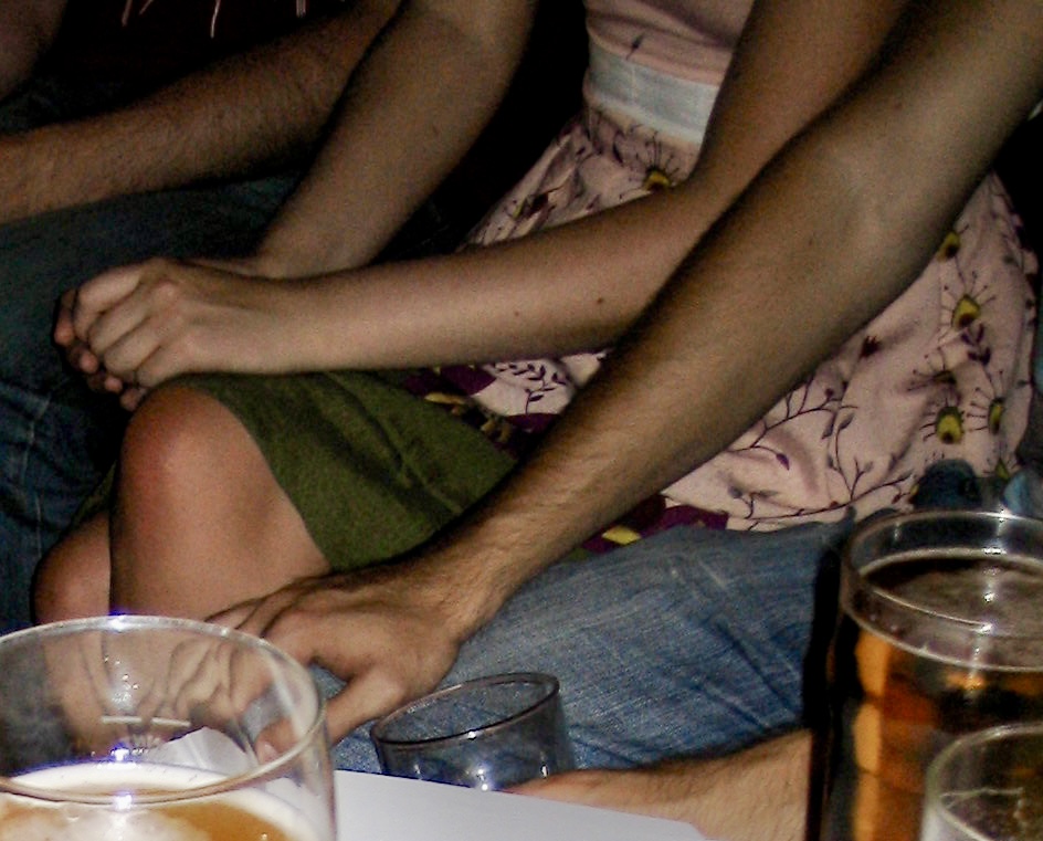 a man sitting on a couch with a drink