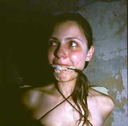 a woman with a knife in her mouth