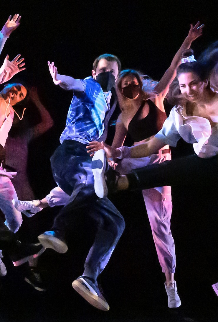 a group of people are dancing on a stage