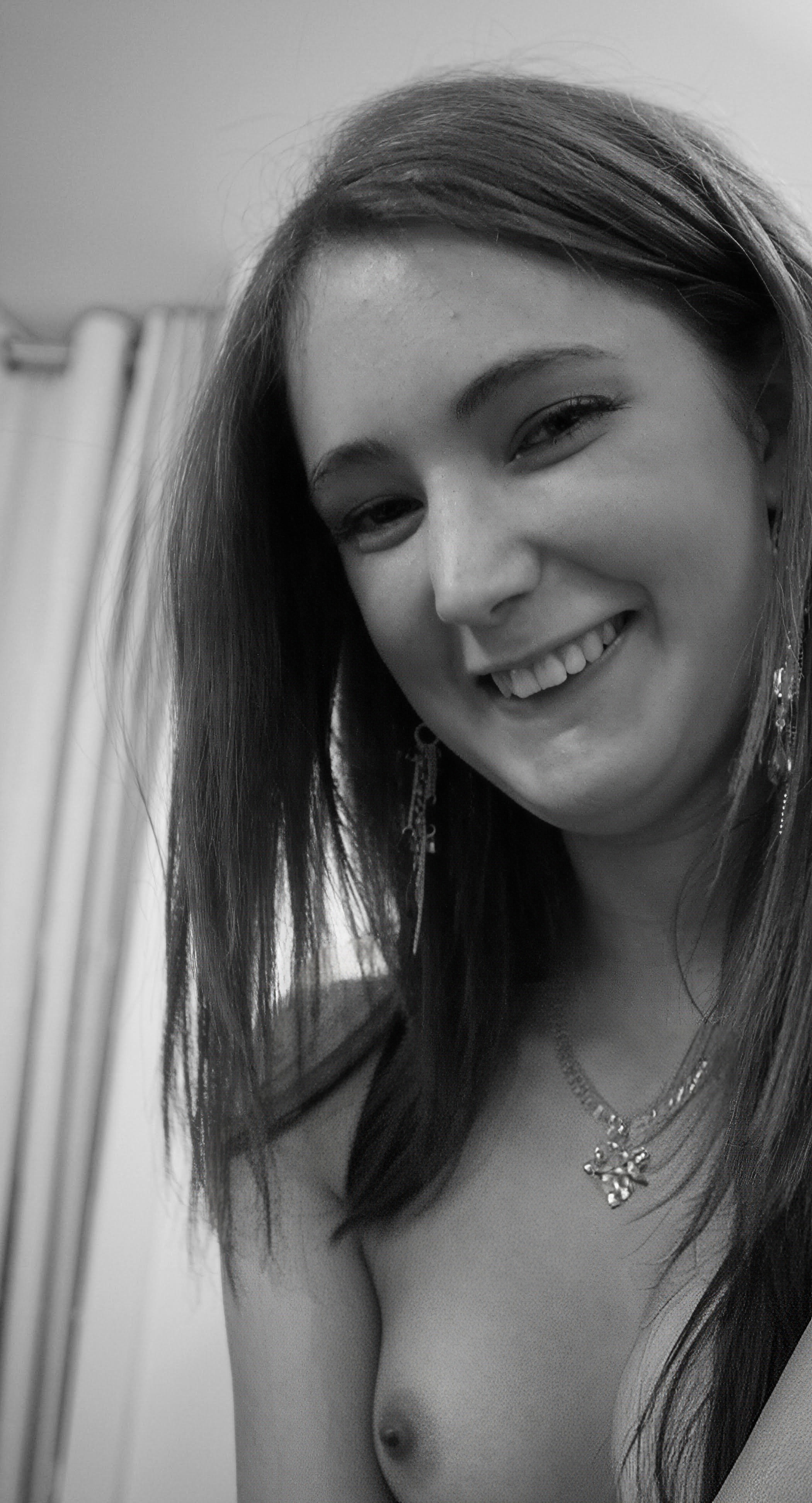 a woman with long hair and a necklace