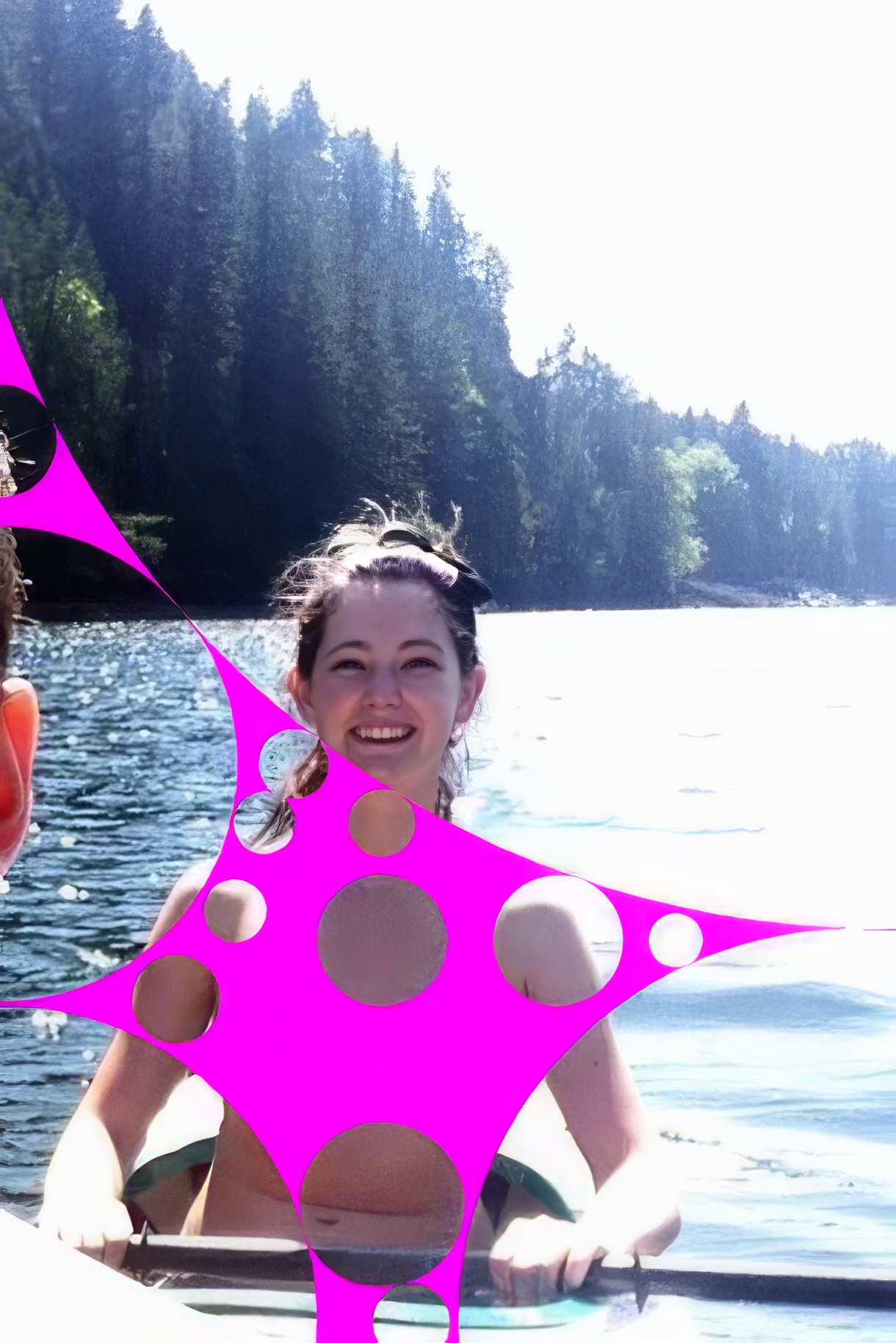 two girls in a boat on a lake