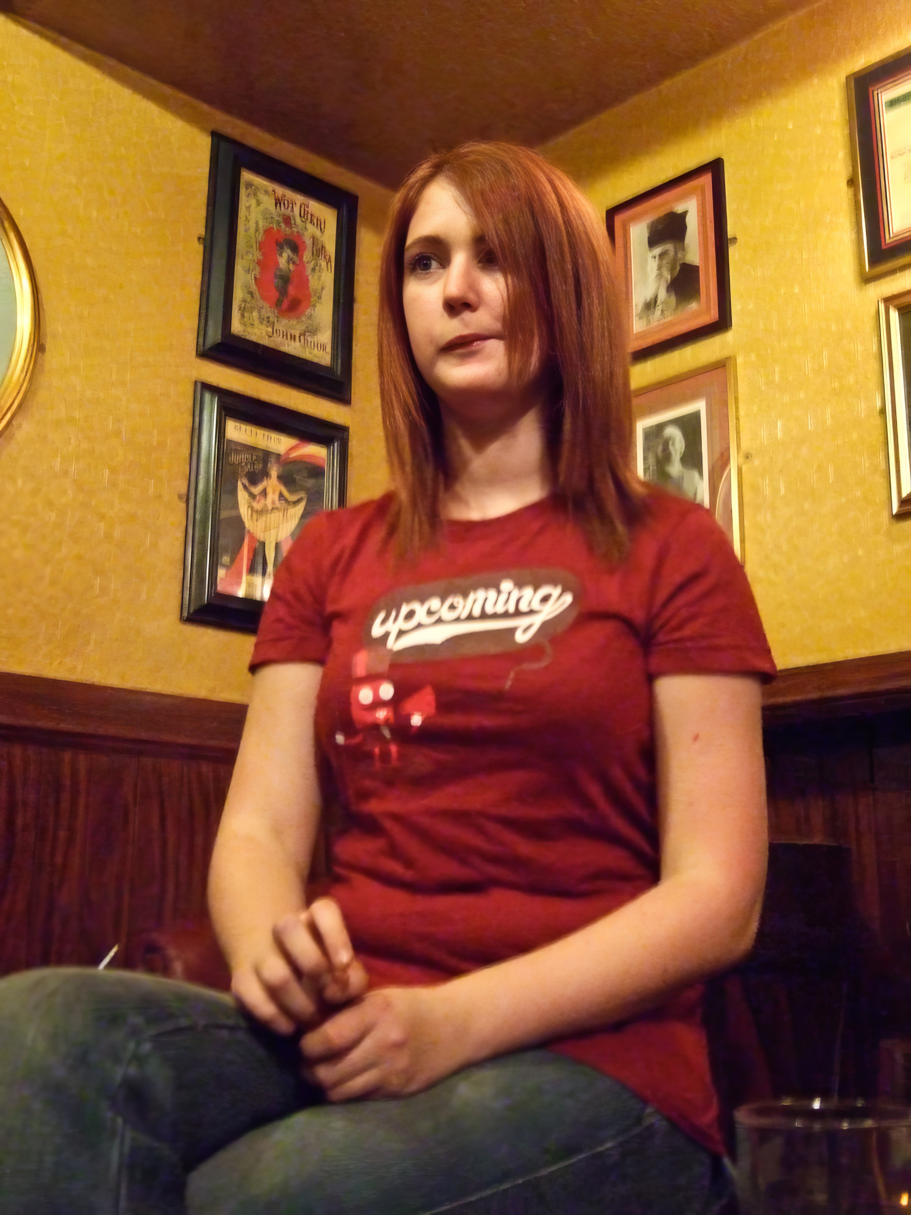 a woman sitting on a chair in a bar