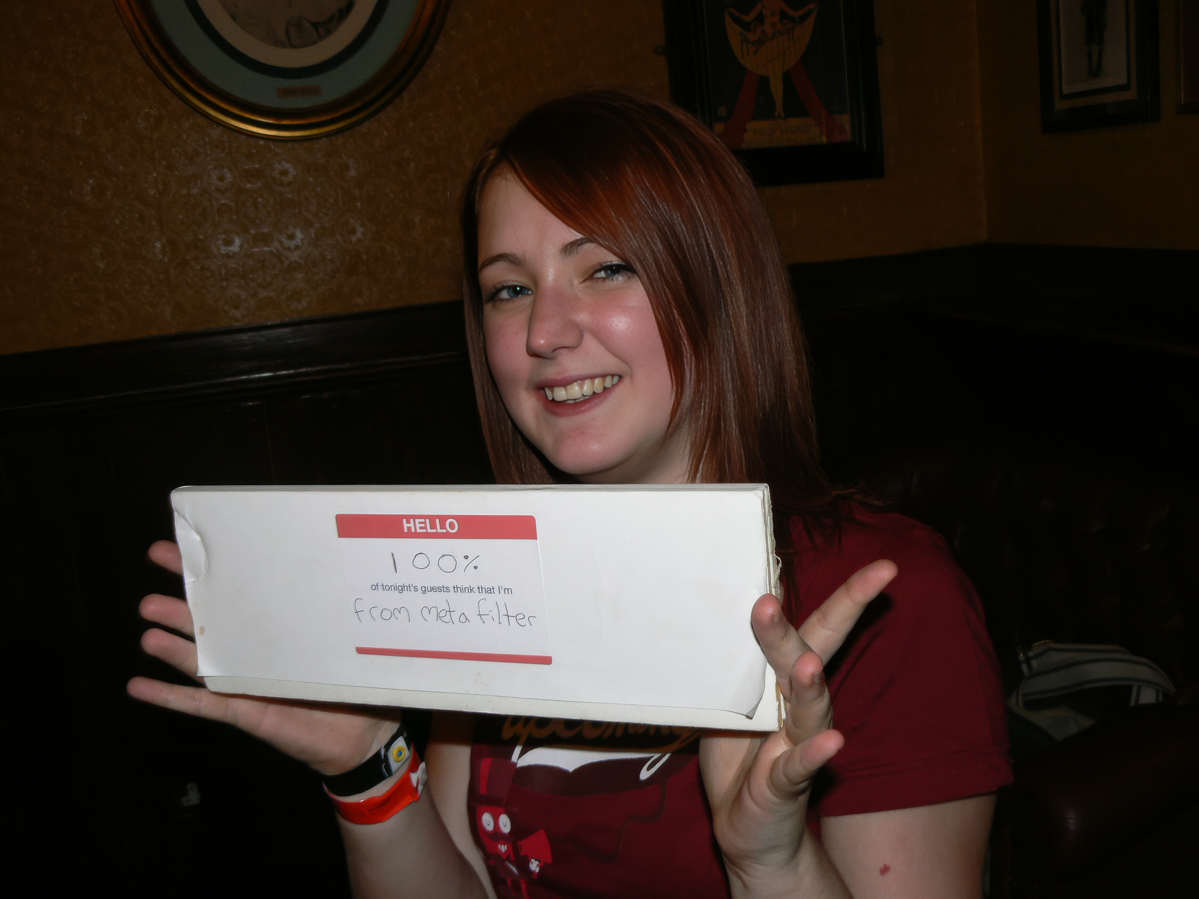 a woman holding a box of pizza