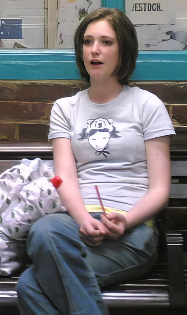 a girl sitting on a bench with a book