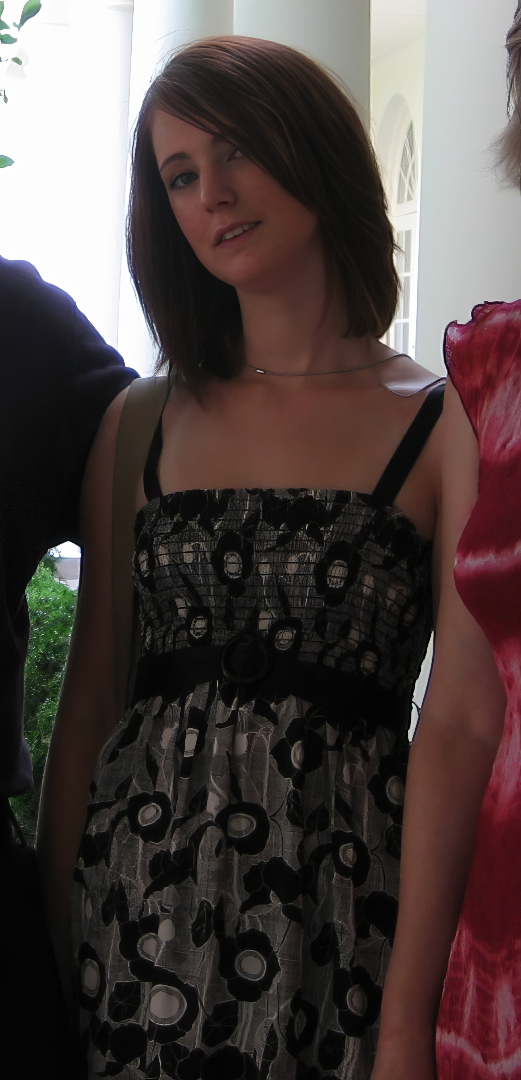 a woman wearing a black and white dress ee