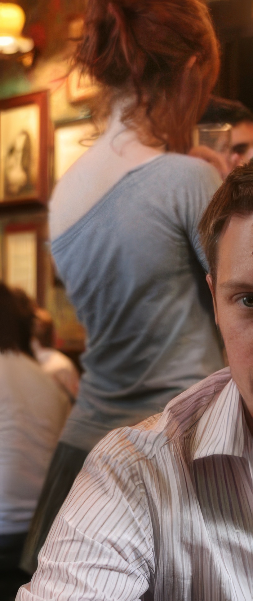 a man sitting at a table with a plate of food