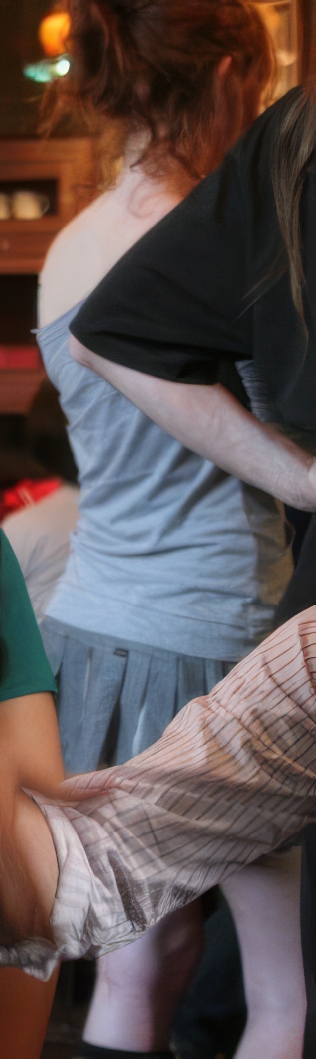 a woman in a dress is cutting a cake