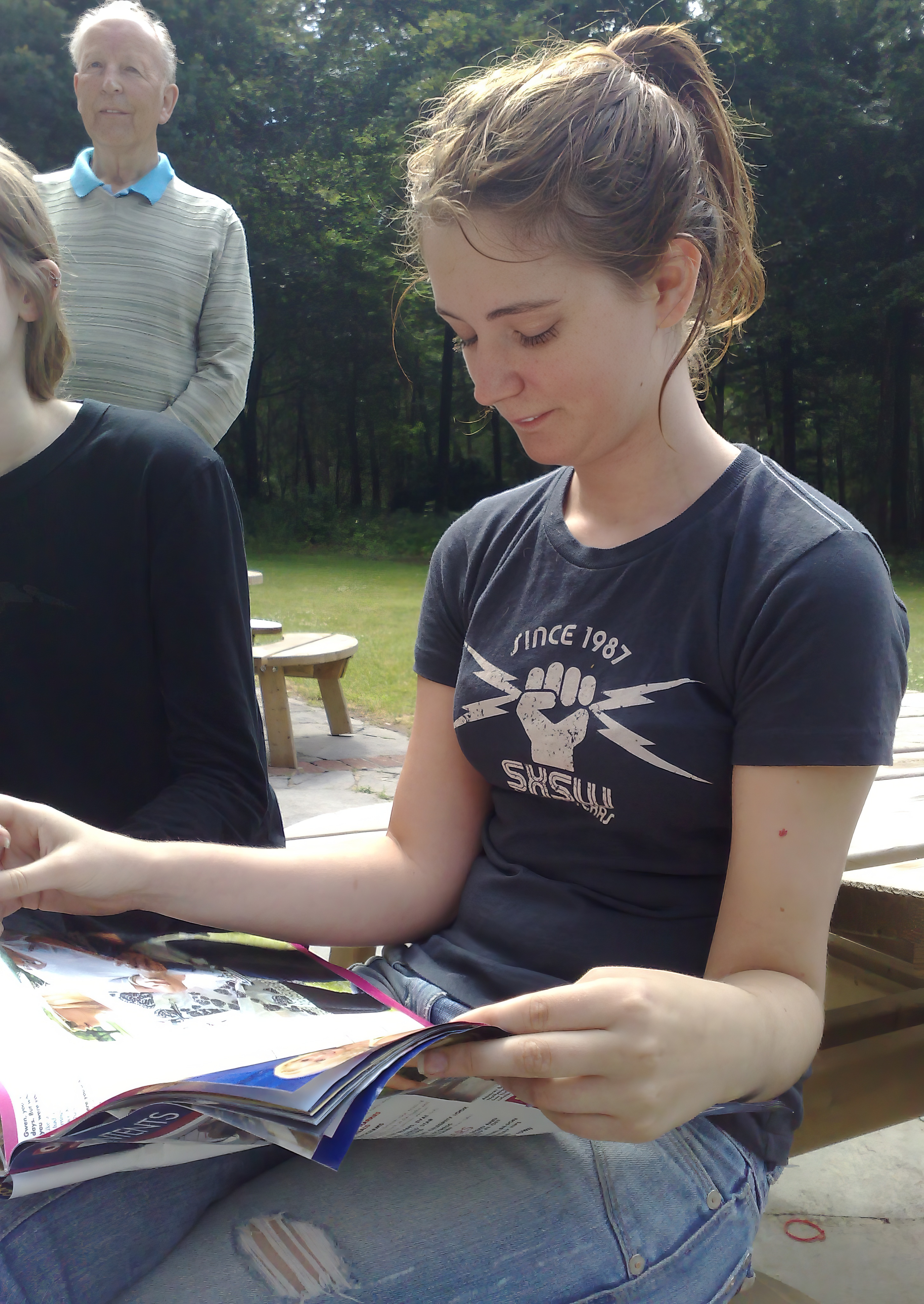 a woman sitting on a bench reading a book