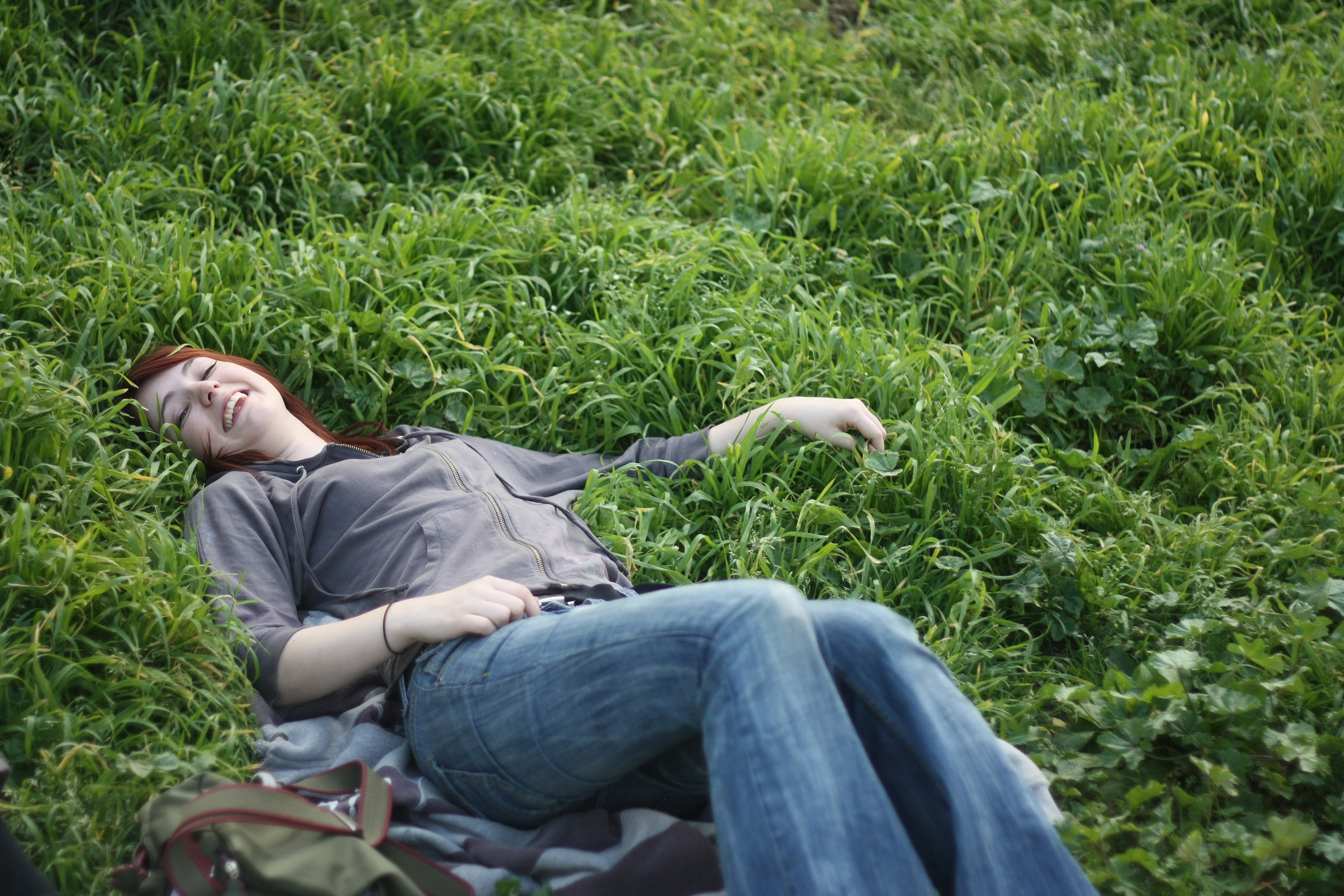 a woman laying in the grass