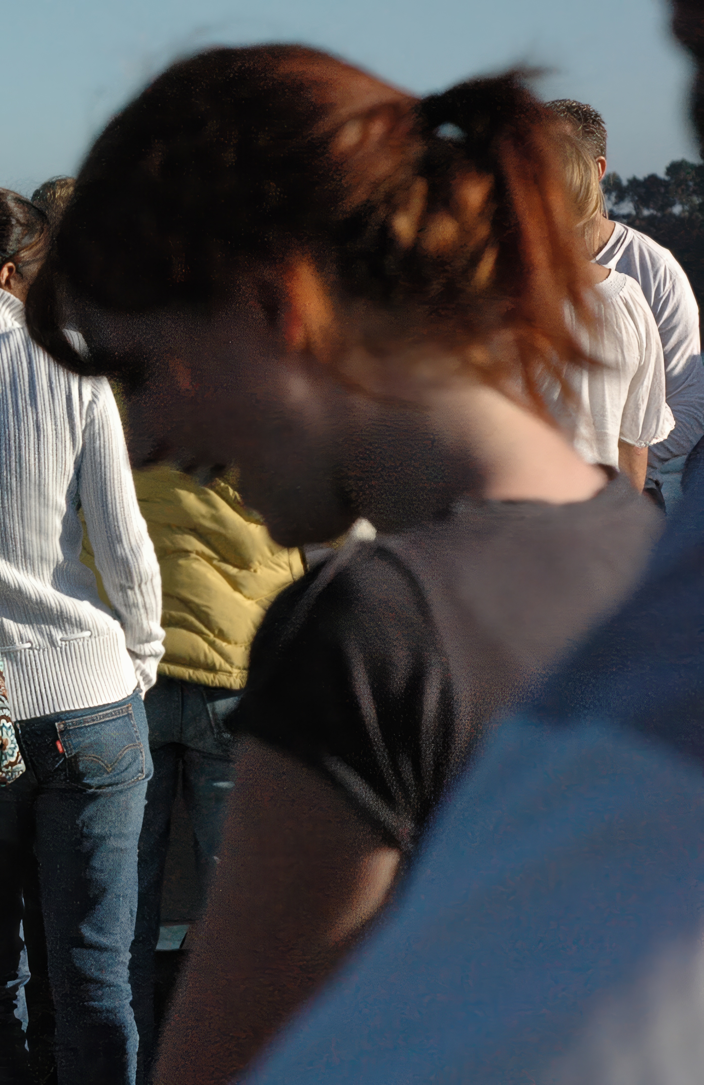 a group of people standing around a man on a skateboard